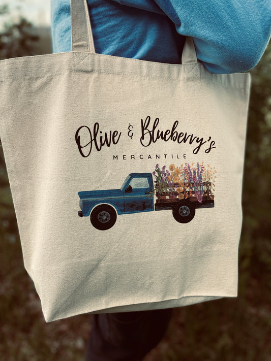 Double sided cotton canvas tote bag showing blue farm truck logo on both sides