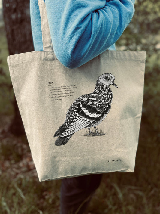 Front view of cotton canvas tote bag featuring a pigeon illustration with a humorous defintion