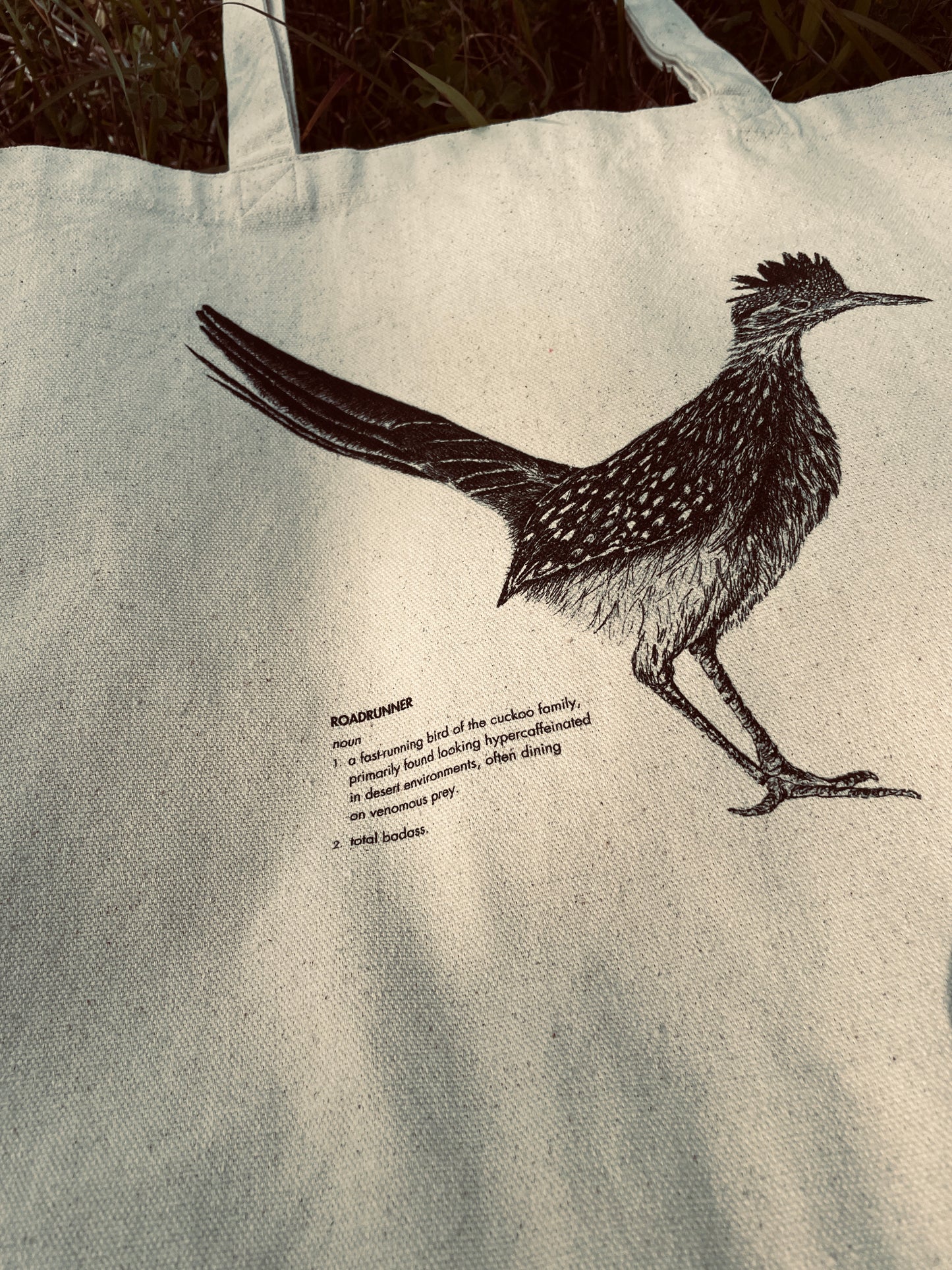 Close-up of realistic roadrunner illustration with humorous definition printed on cotton canvas tote bag